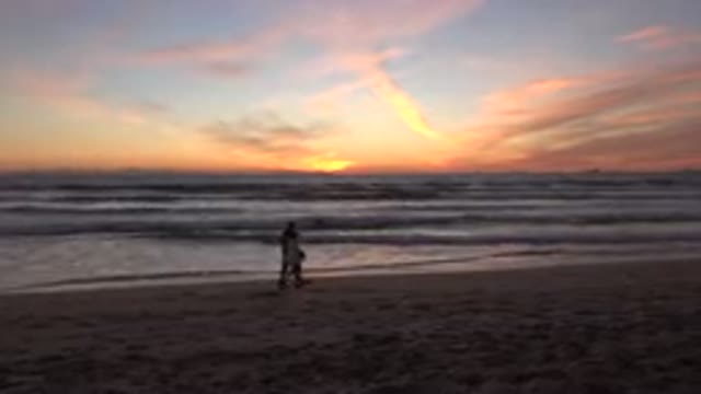 HUNTINGTON BEACH CALIFORNIA-2020: A Couple Enjoying Evening Walk On The Beach