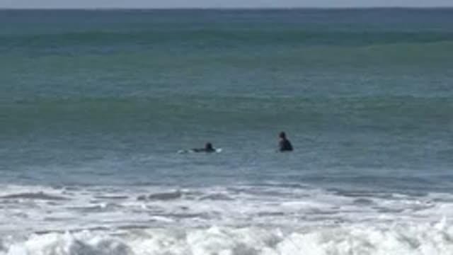 HUNTINGTON BEACH CALIFORNIA-2020: Guys Surfing Together In A Rough Sea During A Sunny Day