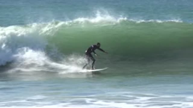 HUNTINGTON BEACH CALIFORNIA-2020: A Man Practicing Surfing At Sea He Wears Swimwear
