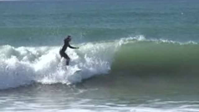 HUNTINGTON BEACH CALIFORNIA-2020: Surfing On The Waves And Falling Off His Surfboard