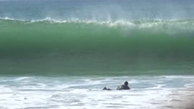 HUNTINGTON BEACH CALIFORNIA-2020: Surfer Rides Big Waves At The Beach