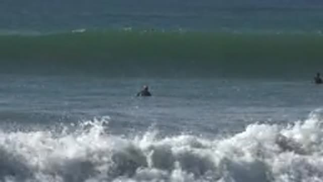 HUNTINGTON BEACH CALIFORNIA-2020: Strong Wave And Surfer In The Sea Waiting To