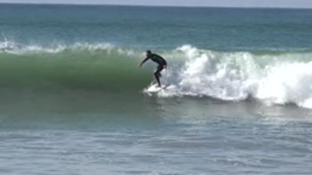 HUNTINGTON BEACH CALIFORNIA-2020: Man Wearing A Black Wetsuit Surfing Very Good