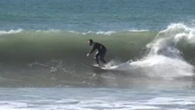 HUNTINGTON BEACH CALIFORNIA-2020: Surfer On Top Of The Wave Performing Stunts