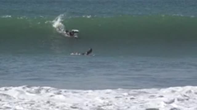 HUNTINGTON BEACH CALIFORNIA-2020: Riding The Giant Waves On The Ocean Laying On Surfboard