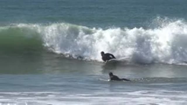 HUNTINGTON BEACH CALIFORNIA-2020: Swimming In Ocean Waves