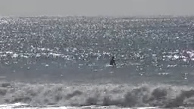 HUNTINGTON BEACH CALIFORNIA-2020: A Person Riding The Waves Out In The Sea