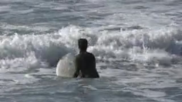 HUNTINGTON BEACH CALIFORNIA-2020: Surfer Tries To Catch A Big Wave To Show His Skills