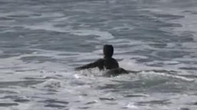 HUNTINGTON BEACH CALIFORNIA-2020: Man Swimming In Sea Water