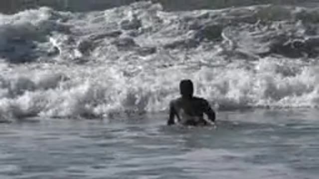 HUNTINGTON BEACH CALIFORNIA-2020: Surfer Swimming Towards A Wave On His Surfboard
