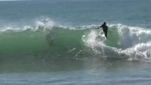 HUNTINGTON BEACH CALIFORNIA-2020: Surfer Coming Out Of The Wave Near Another