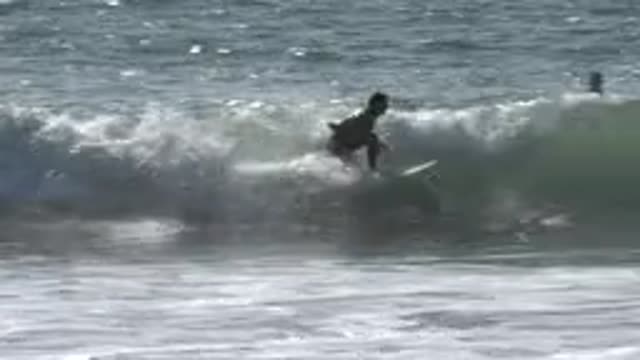 HUNTINGTON BEACH CALIFORNIA-2020: Boy Surfing Waves In The Daytime