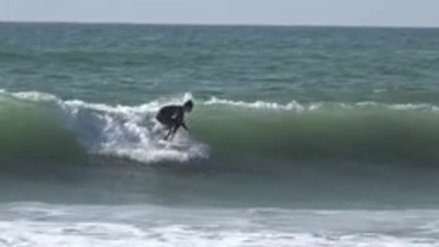 HUNTINGTON BEACH CALIFORNIA-2020: A Man Surfing On A Wave Outdoors During