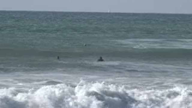 HUNTINGTON BEACH CALIFORNIA-2020: People Floating On Surfboard In The Ocean