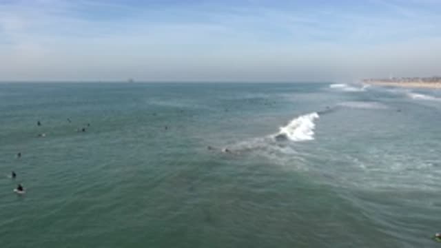 HUNTINGTON BEACH CALIFORNIA-2020: Seaside Waves Crashing with People Swimming