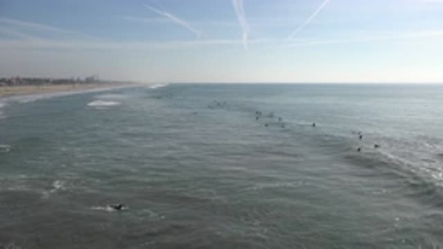 HUNTINGTON BEACH CALIFORNIA-2020: View Of Person Swimming Towards Blue Ocean