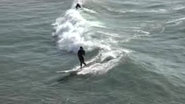 HUNTINGTON BEACH CALIFORNIA-2020: Surfer Keeping Their Balance On A Surfboard