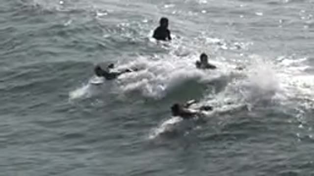 HUNTINGTON BEACH CALIFORNIA-2020: Group Of Men Surfing At The Beach On A Sunny