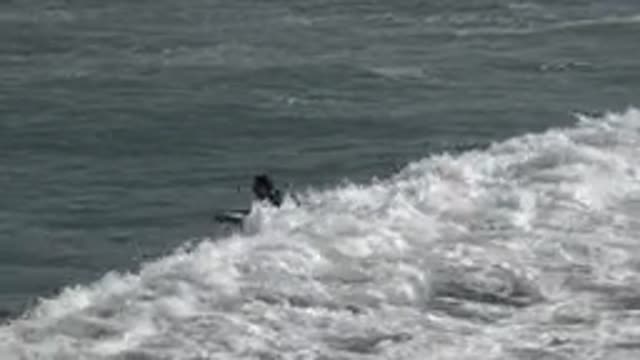 HUNTINGTON BEACH CALIFORNIA-2020: Surfer Takes Advantage Of A Small But Long Wave