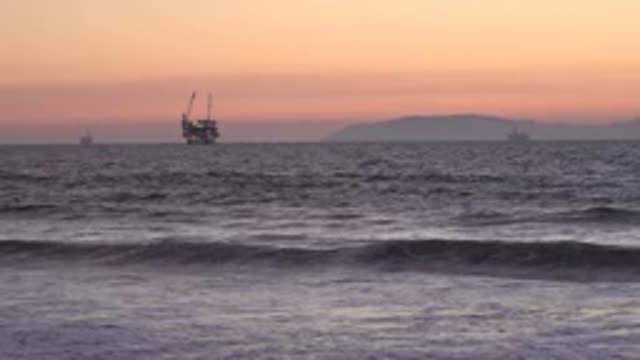 HUNTINGTON BEACH CALIFORNIA-2020: Boat In The Middle Of The Rough Sea At Sunset
