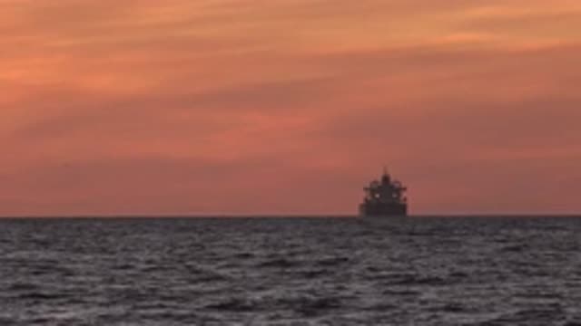 HUNTINGTON BEACH CALIFORNIA-2020: Pretty Orange Sky View Of Tanker Ship On Body