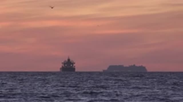 HUNTINGTON BEACH CALIFORNIA-2020: Sea At Sunset With Two Ships That Seem To Be Cruising