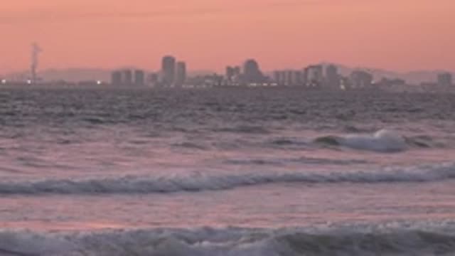 HUNTINGTON BEACH CALIFORNIA-2020: Relaxation On The Beach With A City In The Background