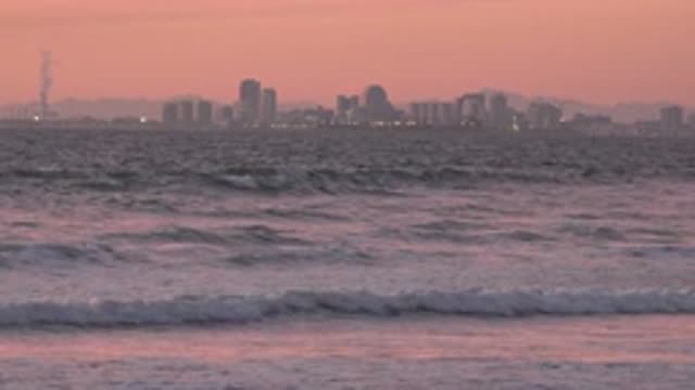 HUNTINGTON BEACH CALIFORNIA-2020: Waves Crashing Against The Seashore With High-Rise Buildings
