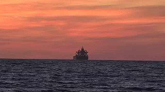 HUNTINGTON BEACH CALIFORNIA-2020: A Big Transport Boat In The Ocean At Sunset