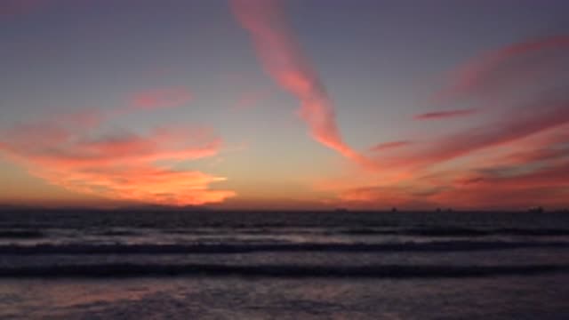 HUNTINGTON BEACH CALIFORNIA-2020: Small Steady Waves Roll Near The Shore At Sunset
