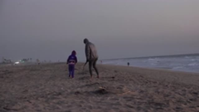 HUNTINGTON BEACH CALIFORNIA-2020: Mother And Son Walking Along The Beach