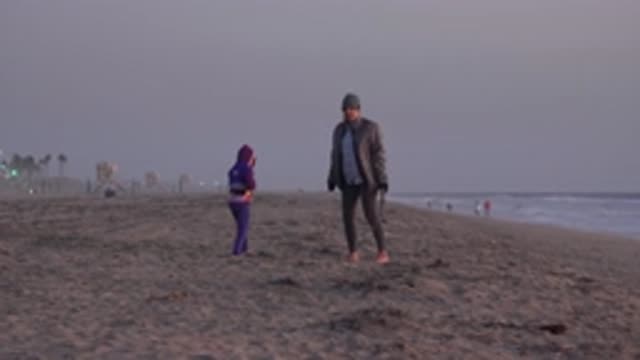 HUNTINGTON BEACH CALIFORNIA-2020: Mom And Little Girl Walking The Beach It's