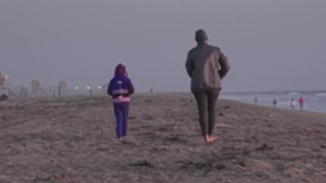 HUNTINGTON BEACH CALIFORNIA-2020: Beach Walking Barefoot on Sand with Couples and Children