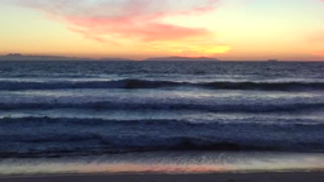 HUNTINGTON BEACH CALIFORNIA-2020: Vibrant Orange Sunset On A Deserted Beach With