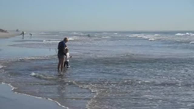 HUNTINGTON BEACH CALIFORNIA-2020: A Woman And A Child Playing On The Beach
