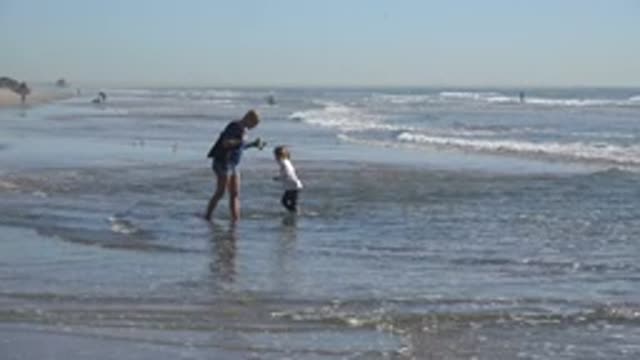 HUNTINGTON BEACH CALIFORNIA-2020: A Day At The Beach Playing In The Ocean With