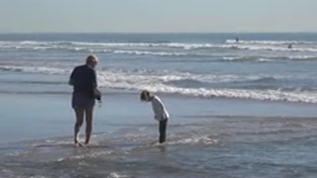 HUNTINGTON BEACH CALIFORNIA-2020: Kid Playing In The Water Of The Beach With A