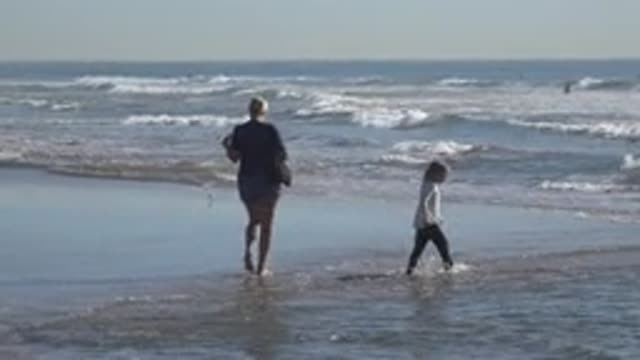 HUNTINGTON BEACH CALIFORNIA-2020: A Mother And Daughter Walking Along The Beach