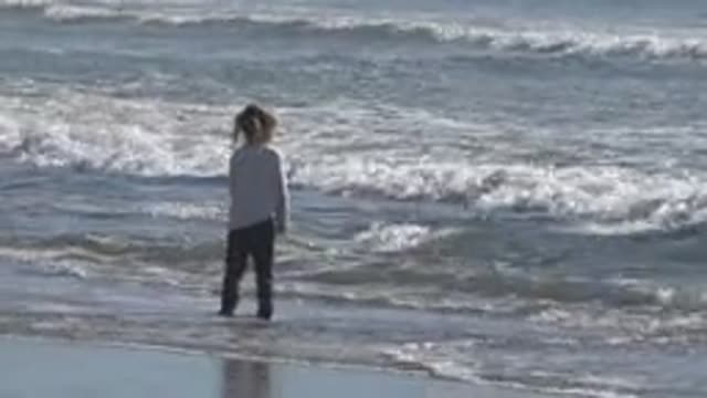 HUNTINGTON BEACH CALIFORNIA-2020: The Innocence Of A Shy Child Facing The Ocean