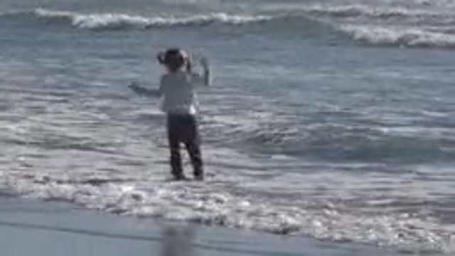 HUNTINGTON BEACH CALIFORNIA-2020: Young Girl Blonde Hair Jumping In The Sea As