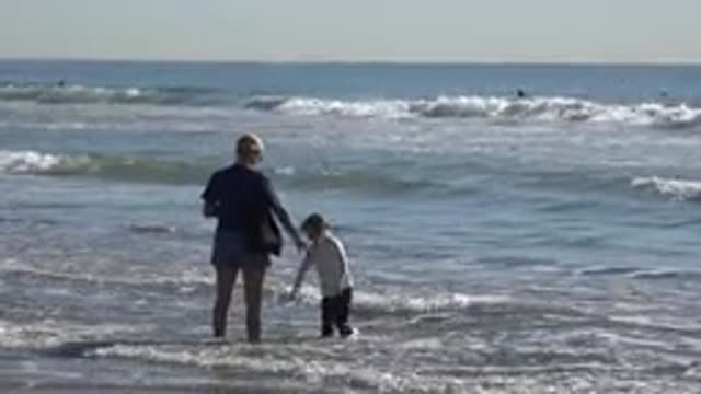 HUNTINGTON BEACH CALIFORNIA-2020: Mother And Her Kid Playing At Beach