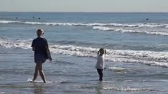 HUNTINGTON BEACH CALIFORNIA-2020: Mother And Her Daughter Walking At The Beach