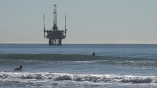 HUNTINGTON BEACH CALIFORNIA-2020: Man Entering The Sea With The Surfboard
