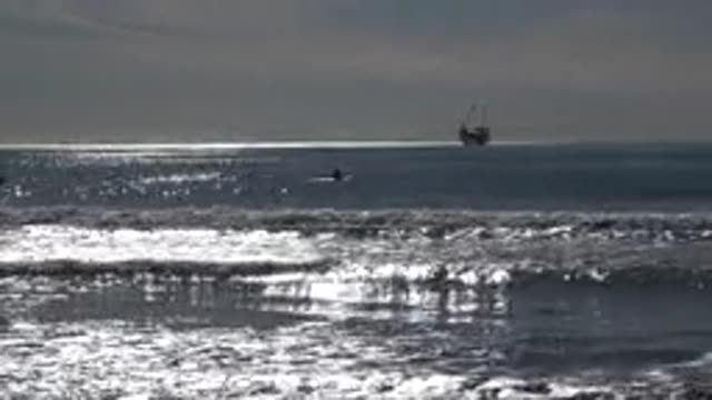 HUNTINGTON BEACH CALIFORNIA-2020: A Small Boat In The Midst Of Rocking Calming