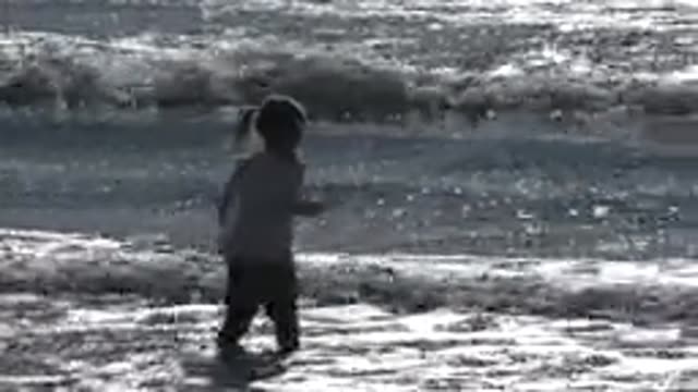 HUNTINGTON BEACH CALIFORNIA-2020: Child Jumping On Clear Sea Water And Having A