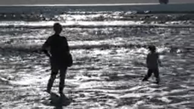 HUNTINGTON BEACH CALIFORNIA-2020: A Little Girl Playing At The Sea With Her Mom