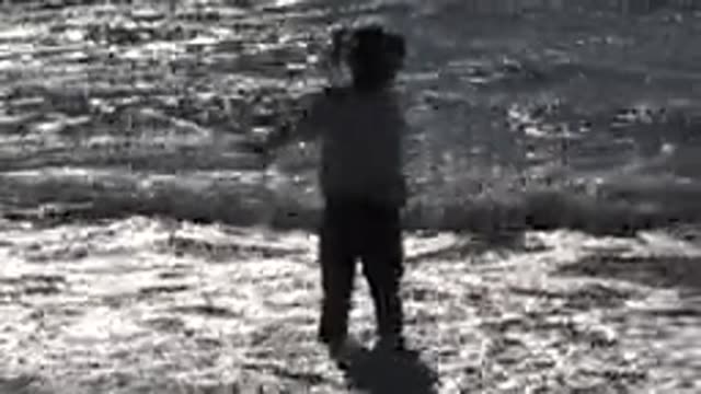HUNTINGTON BEACH CALIFORNIA-2020: Little Girl Jumping in a Wave at the Beach