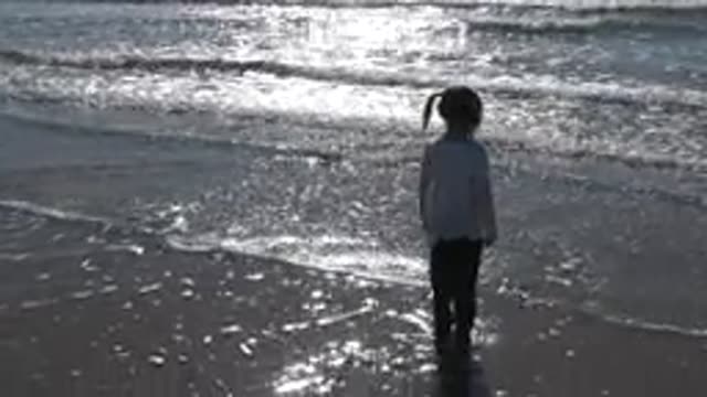 HUNTINGTON BEACH CALIFORNIA-2020: A Little Girl Playing With Ocean Waves