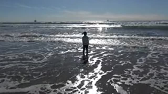 HUNTINGTON BEACH CALIFORNIA-2020: Child Playing And Enjoying The Most Natural