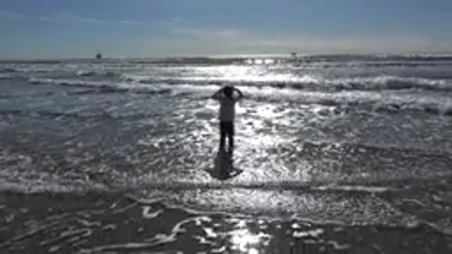 HUNTINGTON BEACH CALIFORNIA-2020: A Young Girl Playing On The Beach